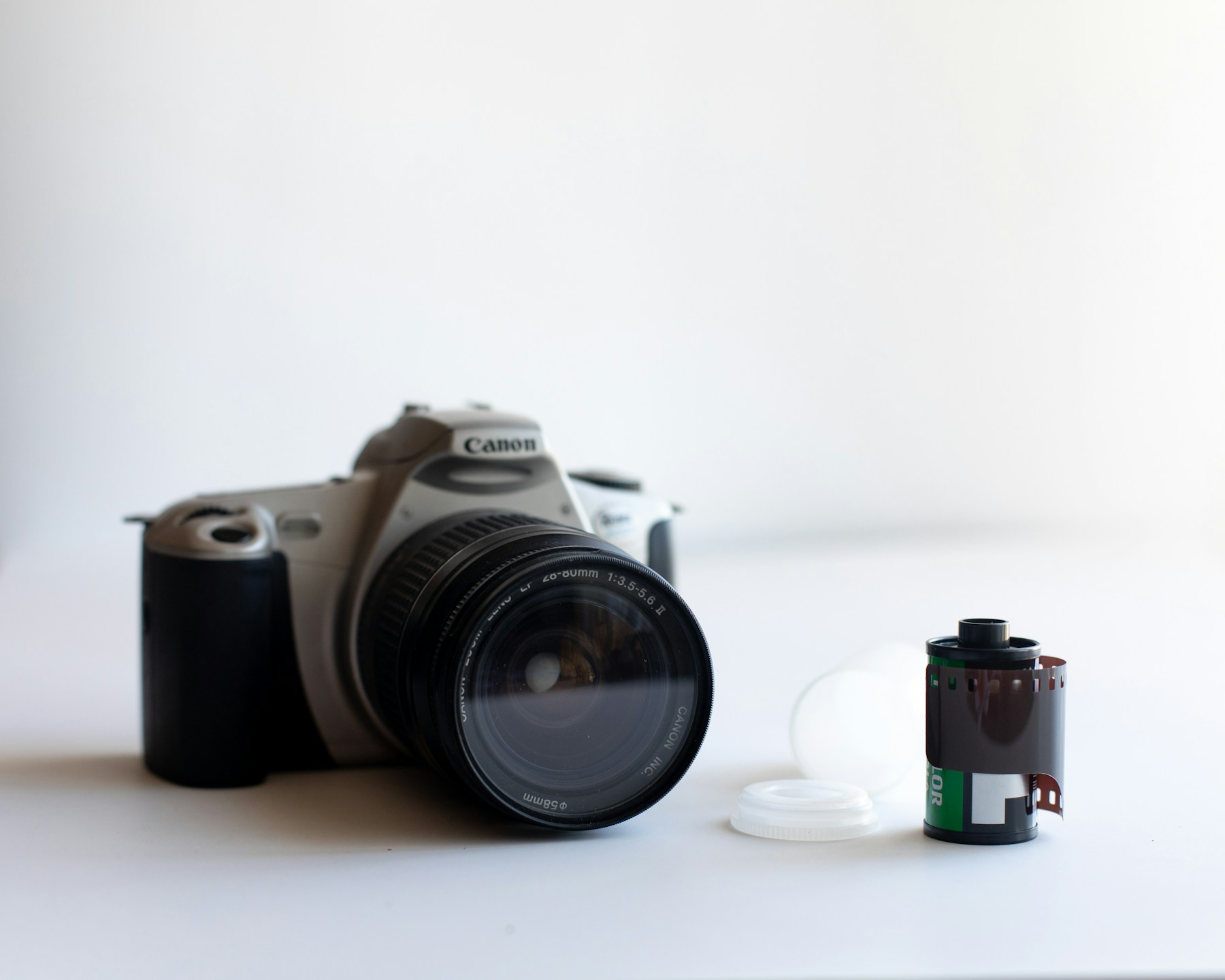 Camera en filmrol op een lichte tafel