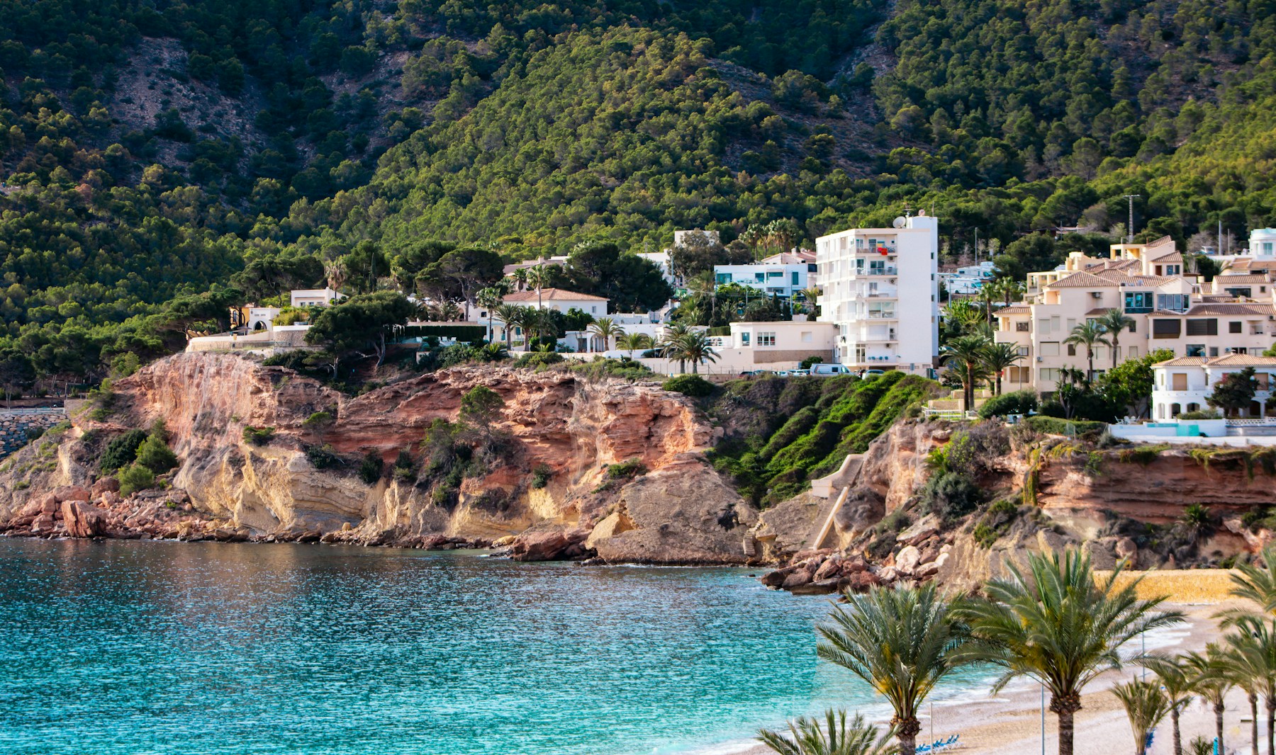 Kust bij El Albir aan de Costa Blanca met palmen en woningen
